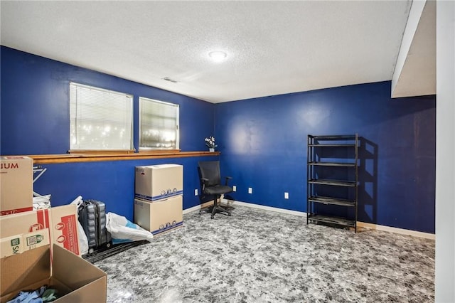 interior space with a textured ceiling and carpet flooring