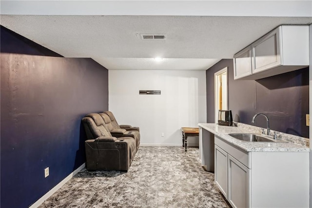 kitchen with a textured ceiling and sink