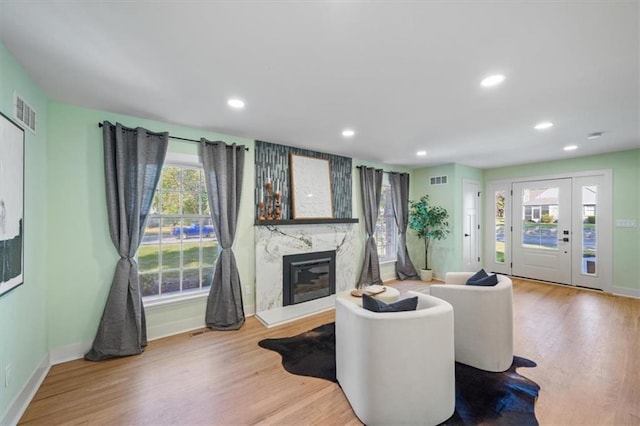 8301 Lee Blvd, Leawood, KS 66206 - living room with visible vents, baseboards, a high end fireplace, recessed lighting, and wood finished floors