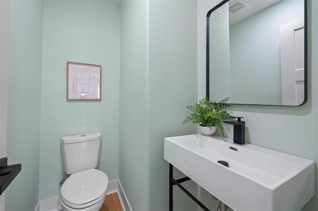 8301 Lee Blvd, Leawood, KS 66206 - bathroom with a sink, visible vents, toilet, and baseboards