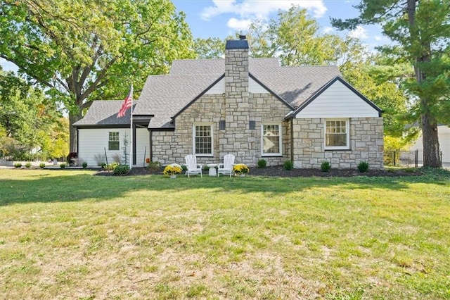 rear view of house featuring a yard