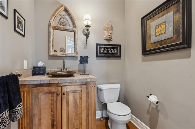 bathroom featuring toilet and vanity