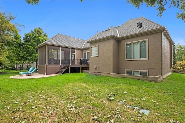 back of house featuring a patio, a lawn, and a sunroom