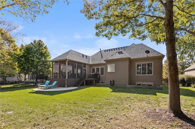 rear view of property with stucco siding, a lawn, a patio, and a sunroom