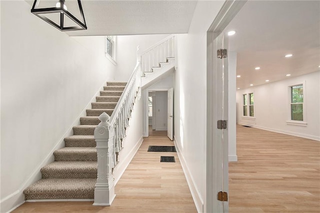 staircase with wood-type flooring