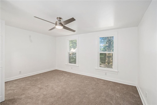 carpeted empty room featuring ceiling fan