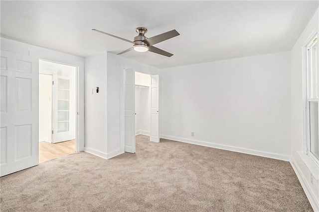 unfurnished bedroom featuring a closet, light colored carpet, and ceiling fan