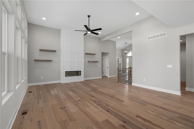 unfurnished living room with ceiling fan and light hardwood / wood-style flooring