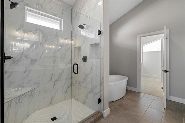 bathroom with a wealth of natural light, tile patterned floors, and shower with separate bathtub