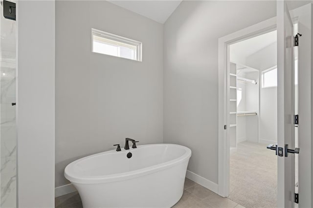 bathroom featuring a washtub and tile patterned floors