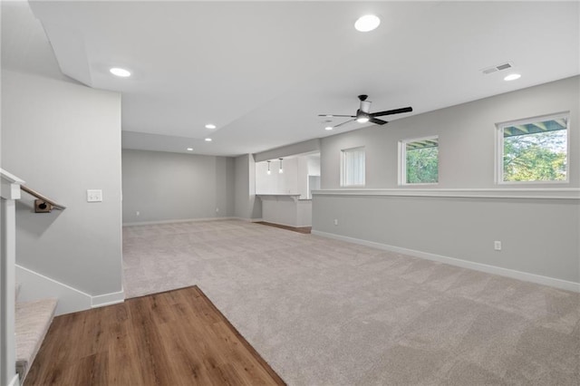 unfurnished room featuring light carpet and ceiling fan