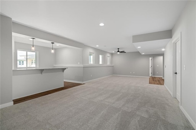 carpeted empty room featuring ceiling fan