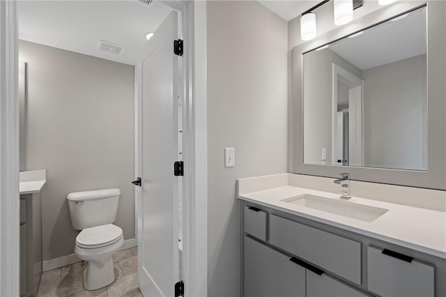 bathroom featuring vanity, toilet, and tile patterned floors