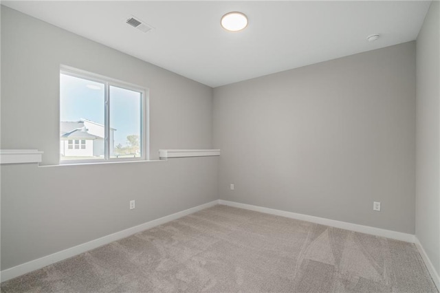 unfurnished room featuring light colored carpet