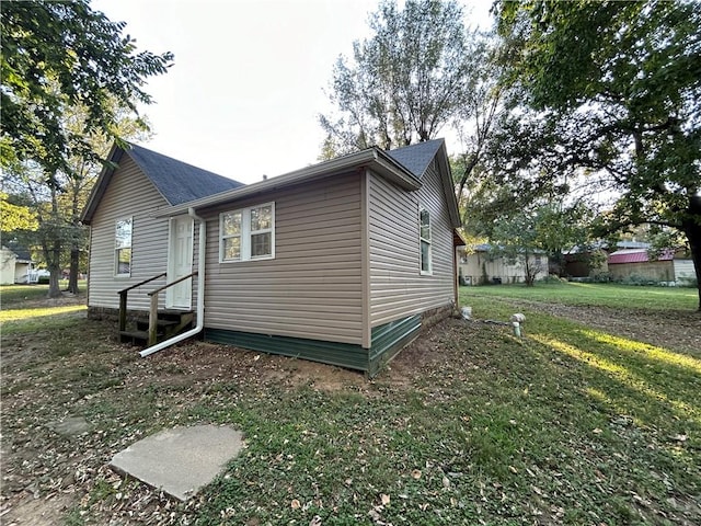 view of home's exterior featuring a lawn