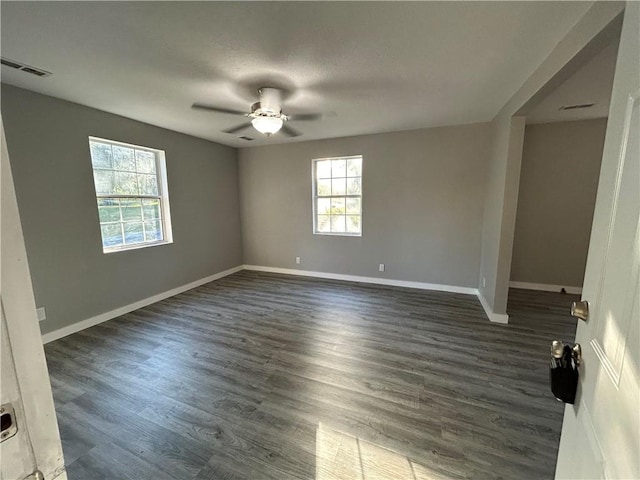 empty room featuring ceiling fan and dark wood-type flooring