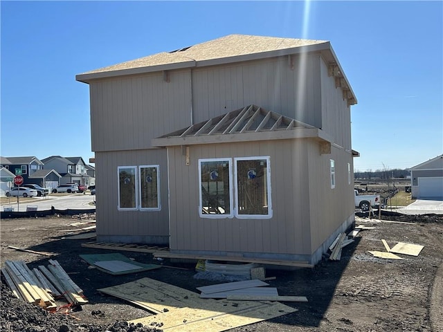 rear view of house with a standing seam roof and metal roof