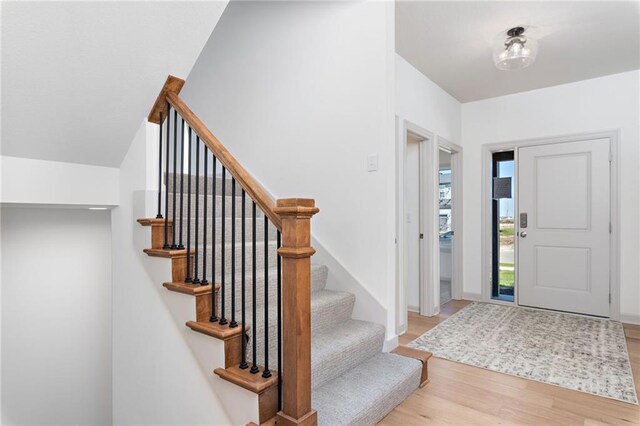 foyer with light wood-style flooring and baseboards