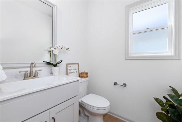 half bathroom featuring toilet and vanity