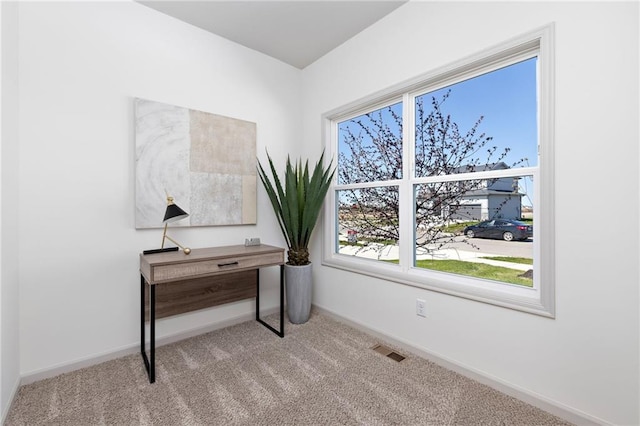 office area featuring carpet floors, visible vents, and baseboards