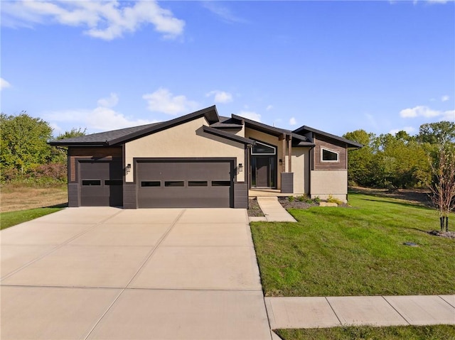 view of front of house with a front yard and a garage