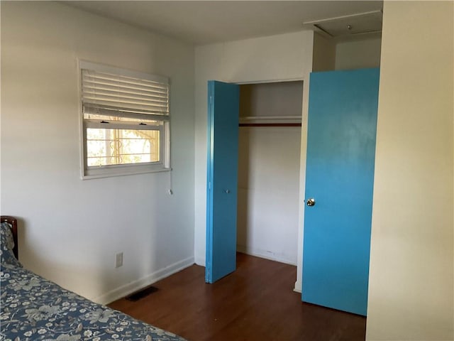 unfurnished bedroom with a closet and dark hardwood / wood-style flooring