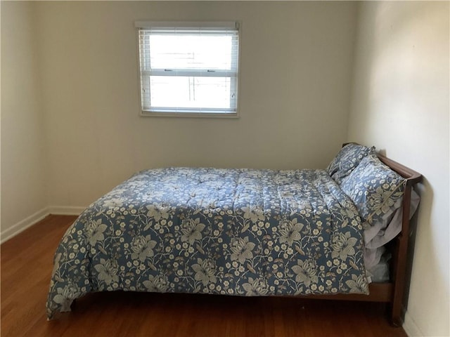 bedroom with hardwood / wood-style flooring