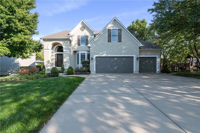 view of front of house with a front yard and a garage