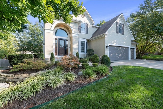 view of front facade featuring a garage and a front lawn