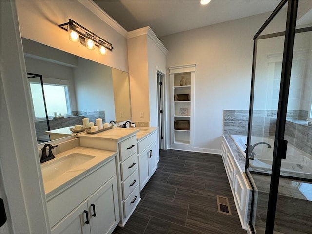 bathroom with vanity and shower with separate bathtub