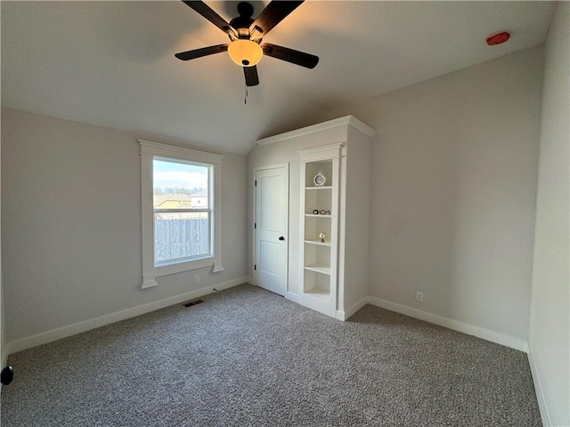 unfurnished bedroom with vaulted ceiling, ceiling fan, and carpet flooring