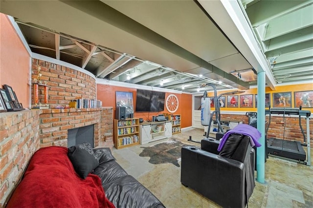 living area featuring a fireplace and unfinished concrete flooring