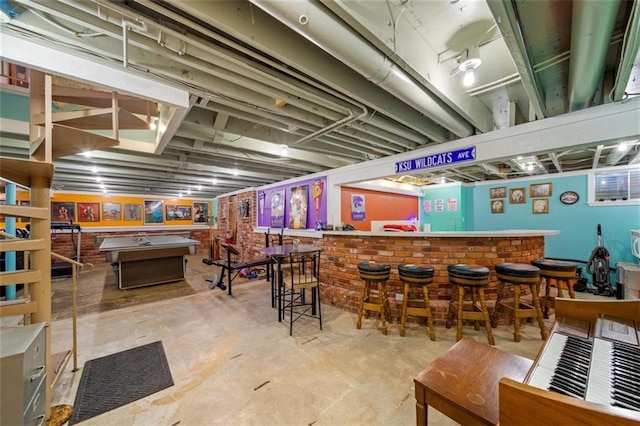 bar with unfinished concrete floors, pool table, and a dry bar
