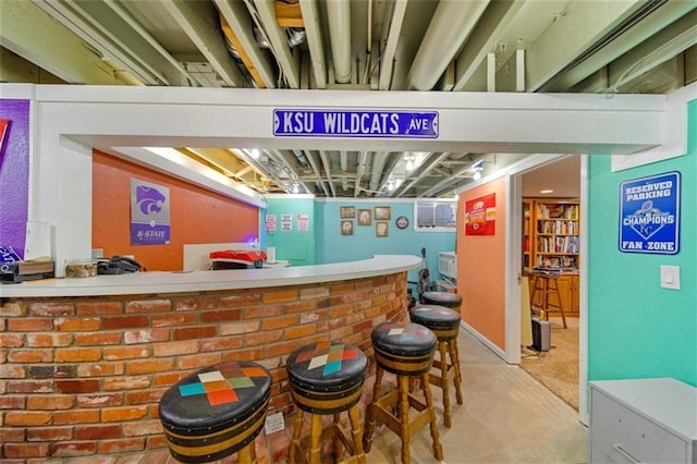bar with bar and unfinished concrete floors