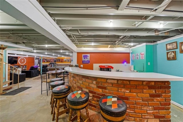 bar featuring a community bar and concrete floors