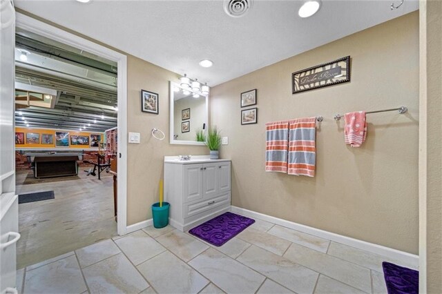 bathroom with recessed lighting, baseboards, and vanity