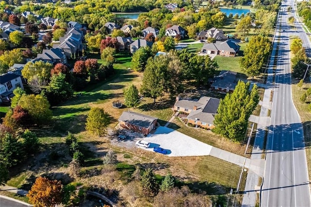 birds eye view of property featuring a water view and a residential view