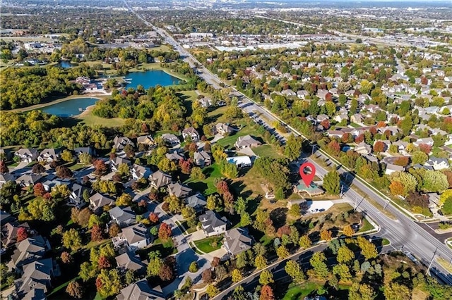 drone / aerial view featuring a water view and a residential view