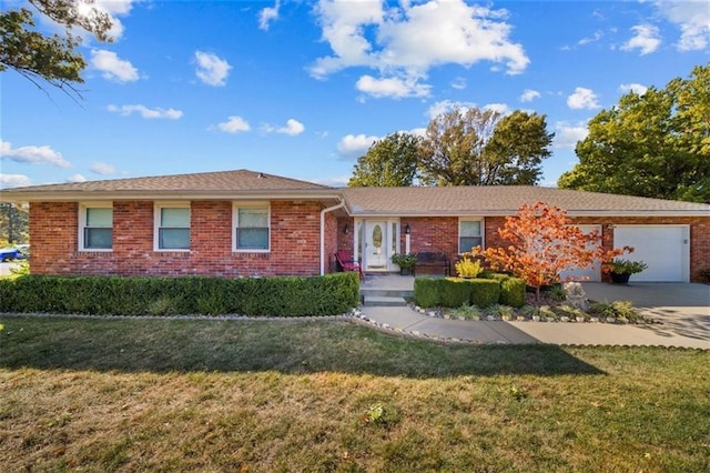 ranch-style home with an attached garage, concrete driveway, a front lawn, and brick siding