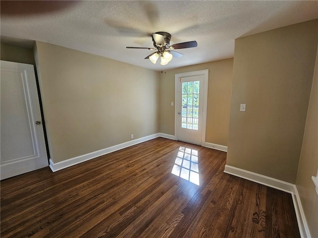 unfurnished room featuring ceiling fan, a textured ceiling, and dark wood-type flooring