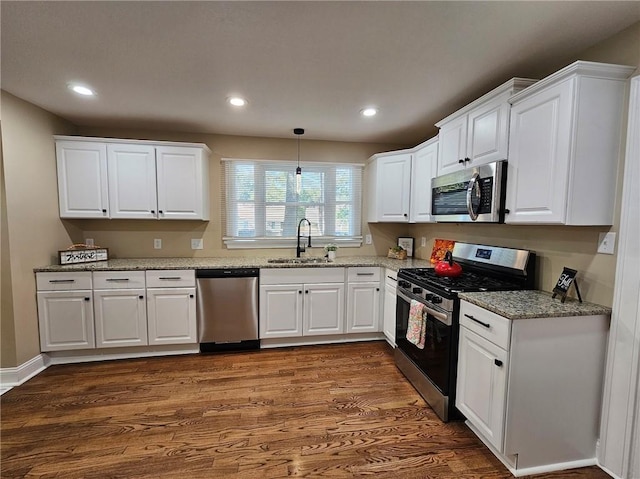 kitchen featuring dark hardwood / wood-style floors, sink, stainless steel appliances, and white cabinets