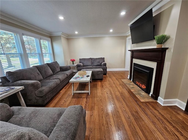 living room featuring a textured ceiling, crown molding, and hardwood / wood-style flooring