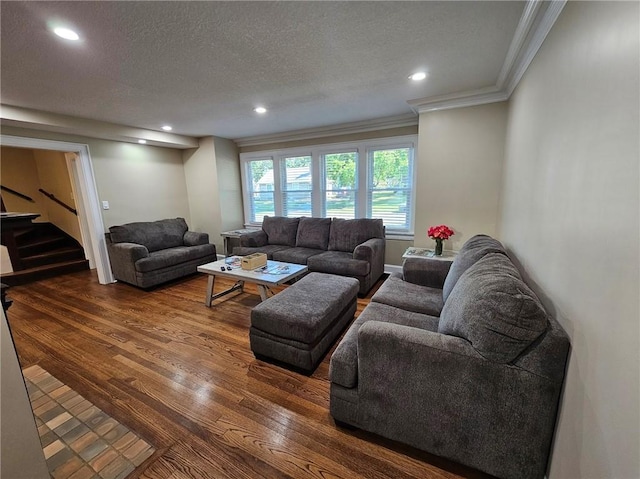 living room featuring a textured ceiling, crown molding, and hardwood / wood-style floors