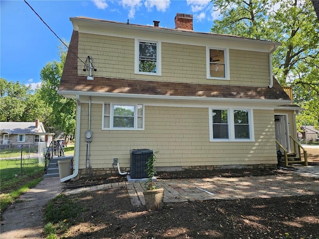 rear view of property with cooling unit