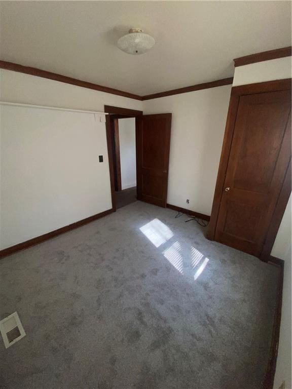 unfurnished room featuring light carpet and ornamental molding