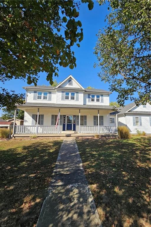 view of front of house with a porch and a front lawn