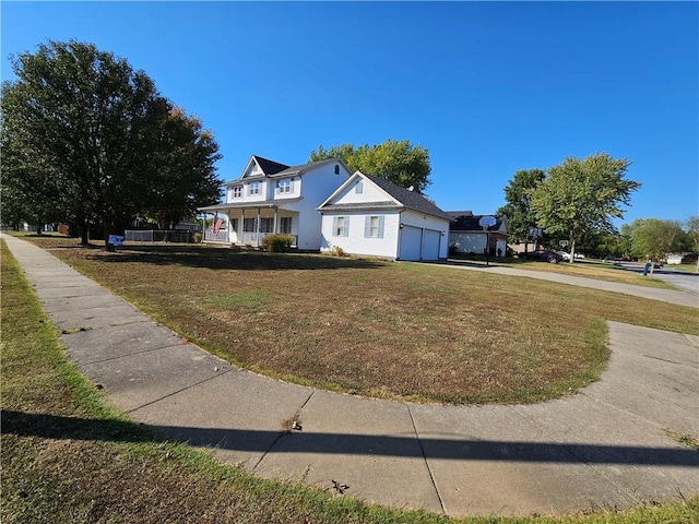 view of front facade featuring a front lawn, a porch, and a garage