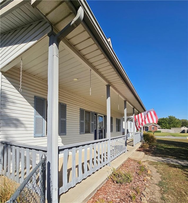 view of side of property with a porch