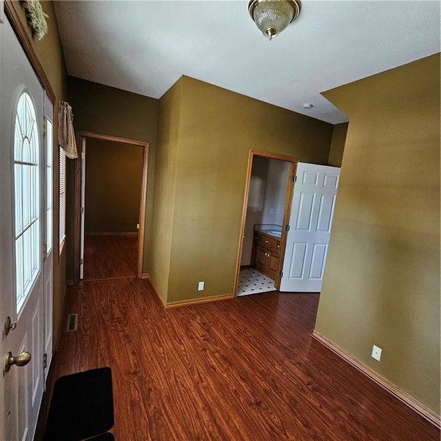 empty room with dark wood-type flooring