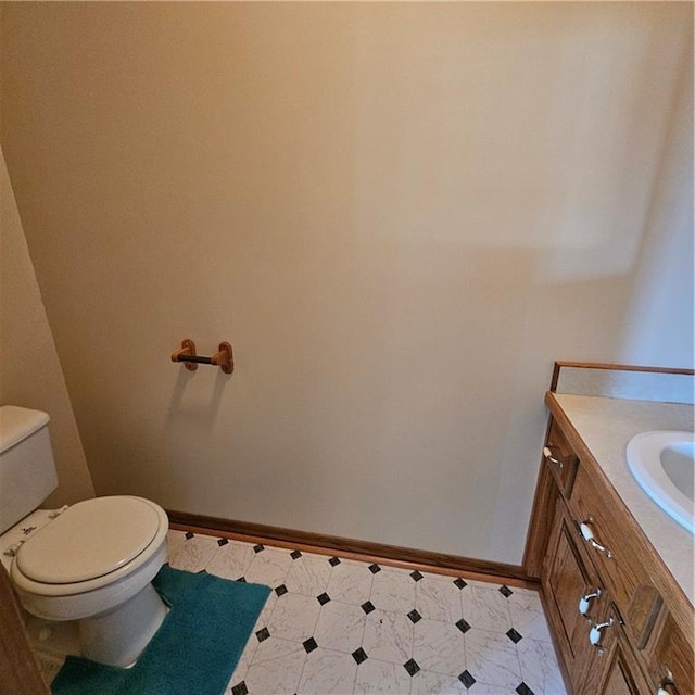 2007 Windsor Dr, Pittsburg, KS 66762 - bathroom with tile patterned floors, vanity, toilet, and baseboards